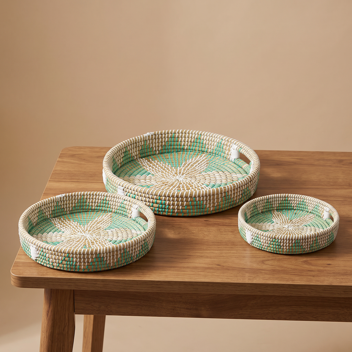 Woven multicolor serving trays in kans grass
